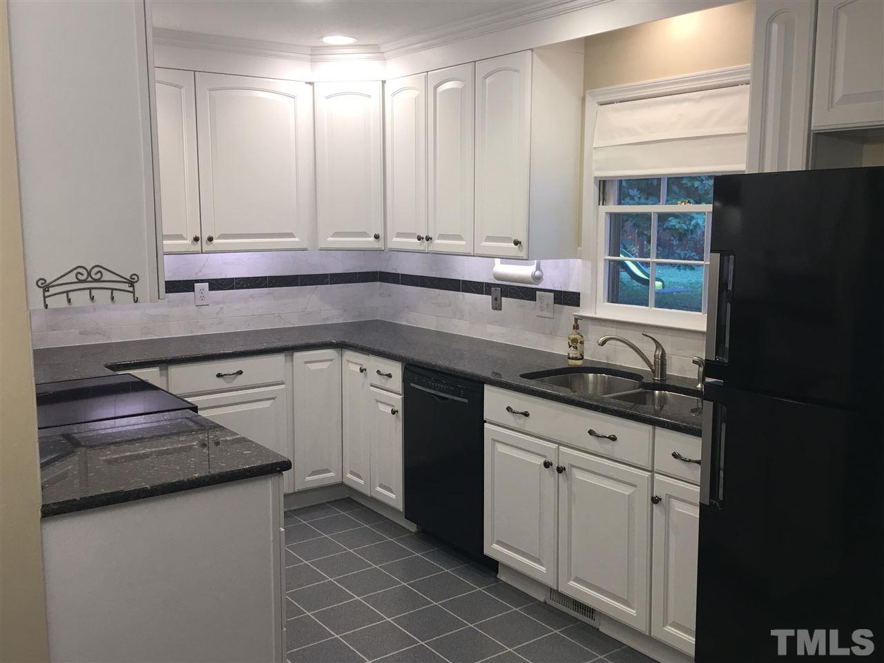 925 Pebblebrook Drive Raleigh, NC 27609 - Photo 6 of 23 a kitchen with granite countertop a sink stainless steel appliances and cabinets