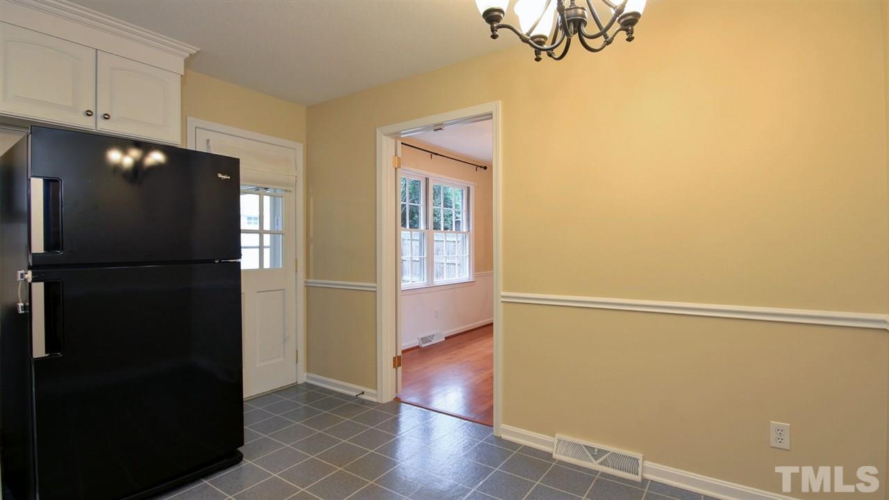 925 Pebblebrook Drive Raleigh, NC 27609 - Photo 7 of 23 a view of an empty room with wooden floor and a window