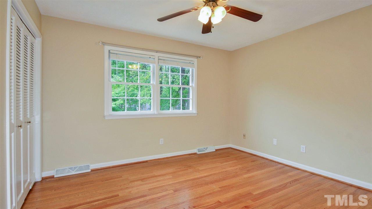 925 Pebblebrook Drive Raleigh, NC 27609 - Photo 8 of 23 an empty room with a window and a chandelier fan