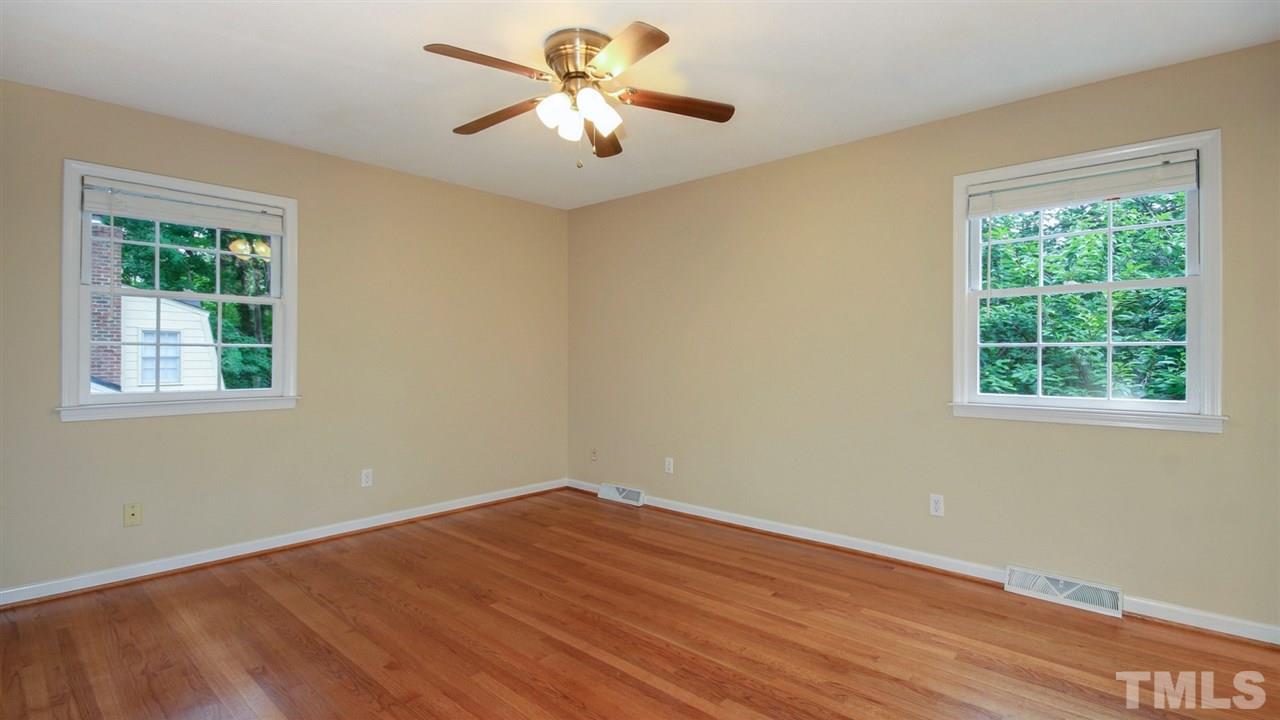 925 Pebblebrook Drive Raleigh, NC 27609 - Photo 9 of 23 a view of empty room with wooden floor and fan