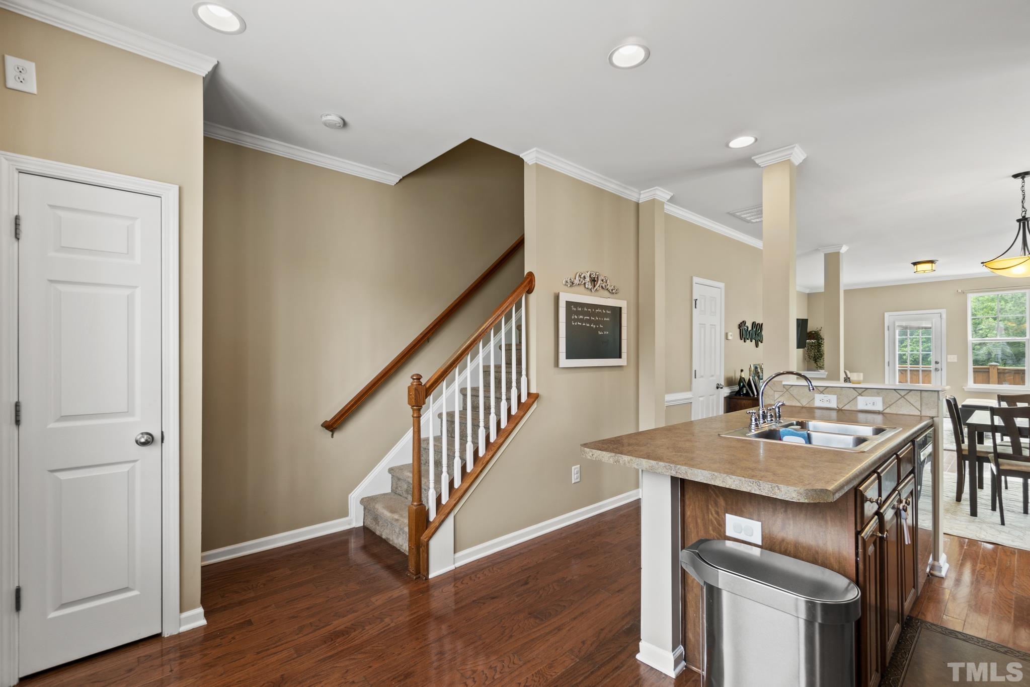 2956 Casona Way Raleigh, NC 27616 - Photo 12 of 27 a view of a dining room with furniture a rug and wooden floor