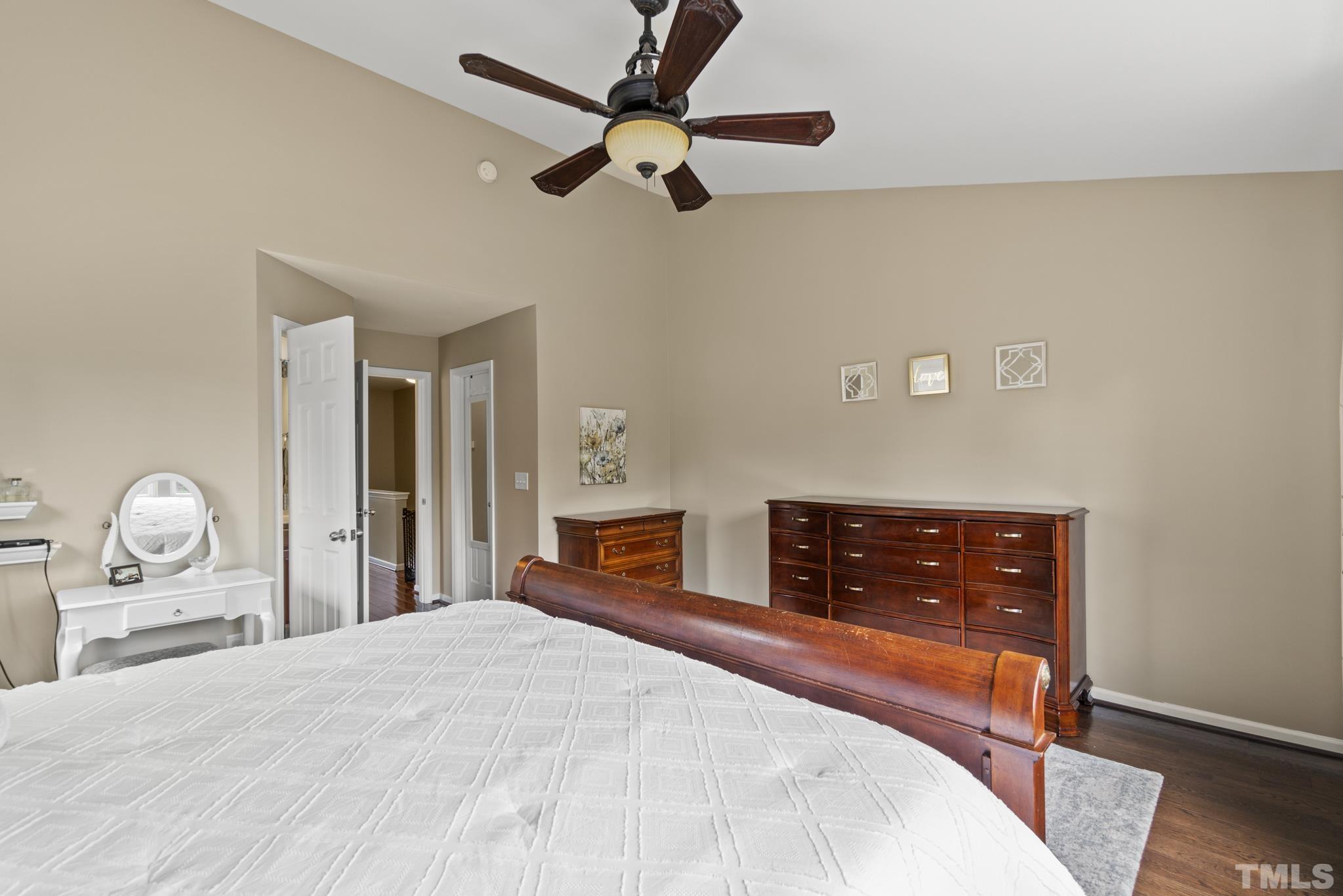 2956 Casona Way Raleigh, NC 27616 - Photo 15 of 27 a bedroom with a bed and wooden floor