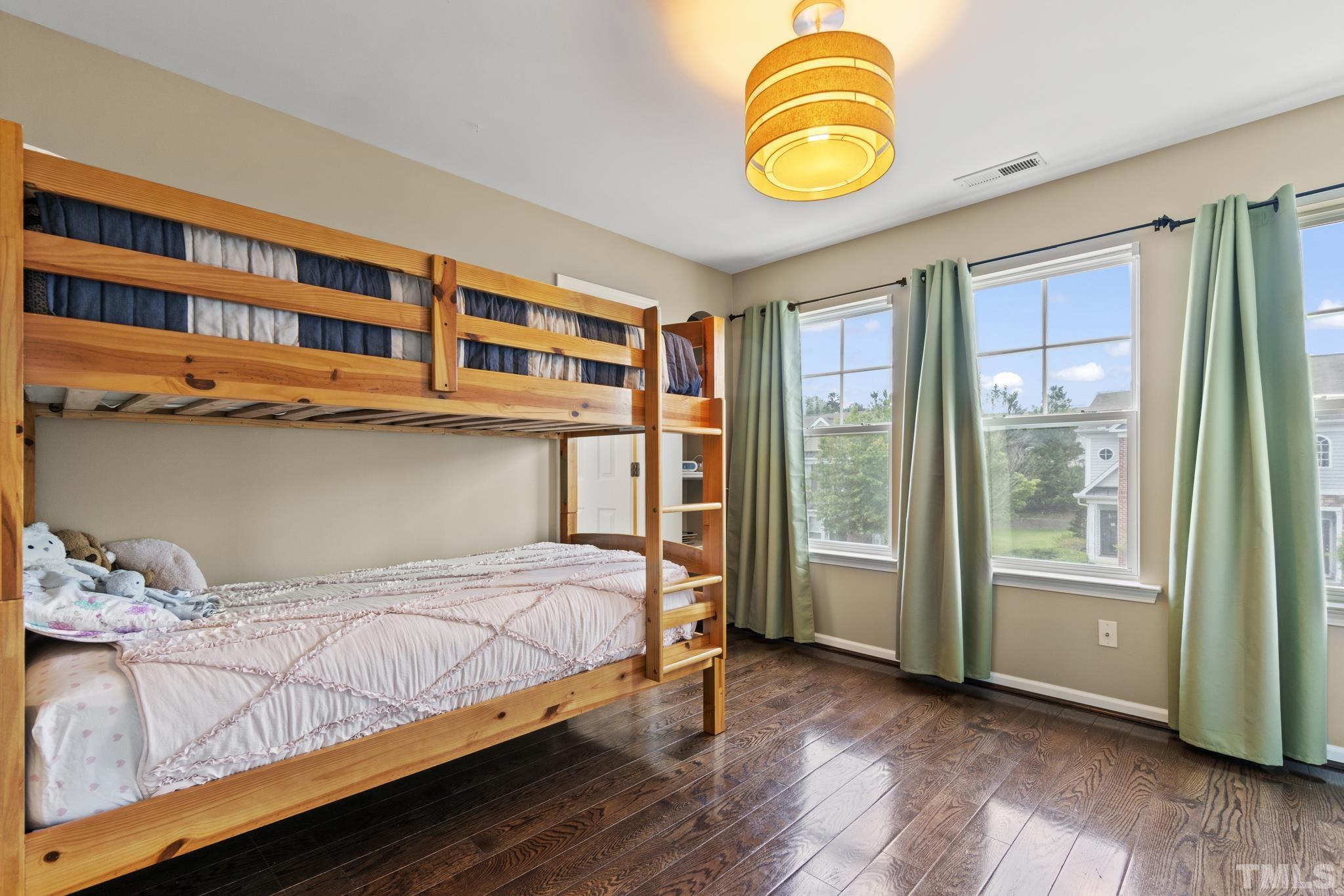 2956 Casona Way Raleigh, NC 27616 - Photo 17 of 27 a bedroom with a bed and wooden floor