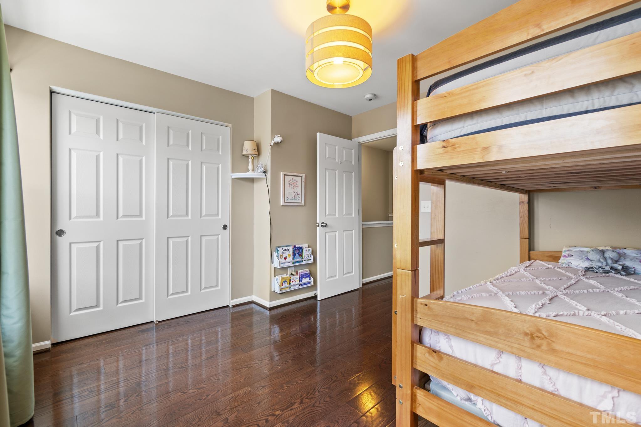 2956 Casona Way Raleigh, NC 27616 - Photo 19 of 27 a view of a bedroom with wooden floor and window