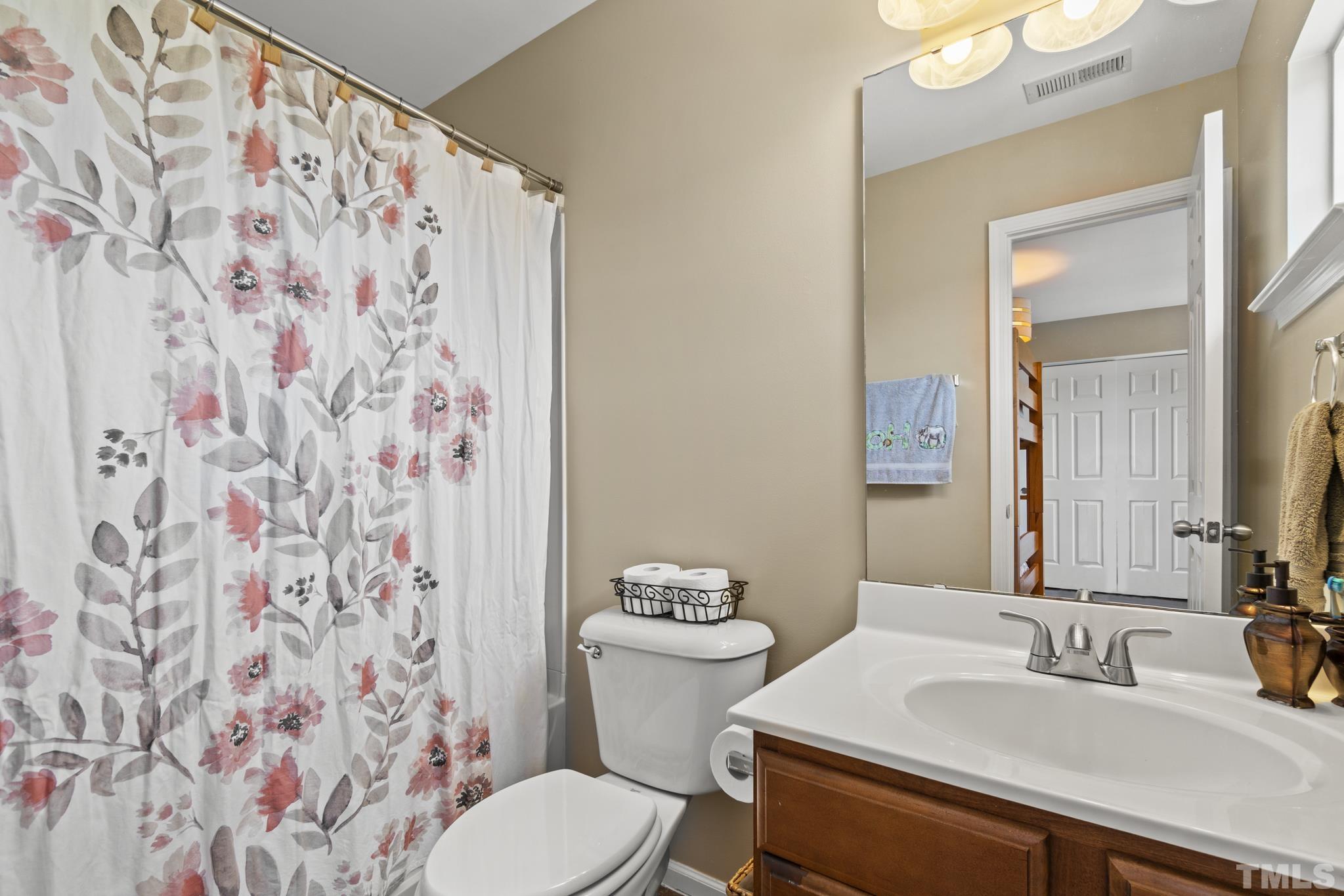 2956 Casona Way Raleigh, NC 27616 - Photo 20 of 27 a bathroom with a sink and a toilet