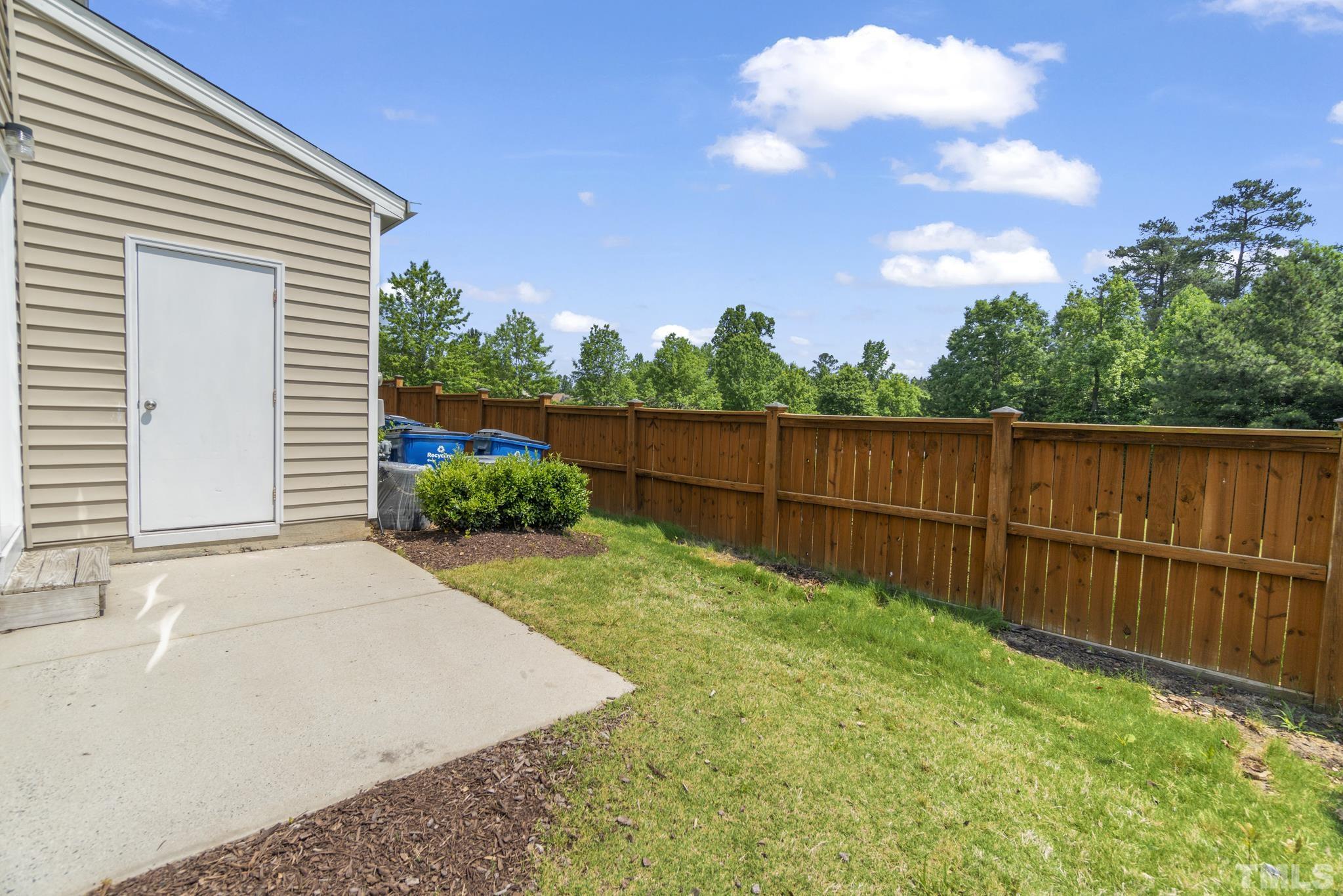 2956 Casona Way Raleigh, NC 27616 - Photo 25 of 27 a view of a backyard with a large tree