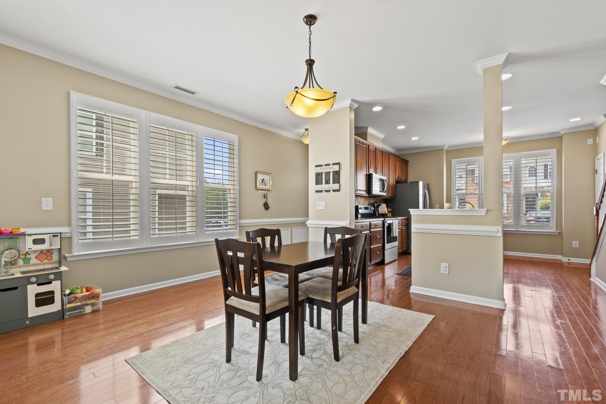 2956 Casona Way Raleigh, NC 27616 - Photo 5 of 27 a view of a dining room with furniture window and wooden floor