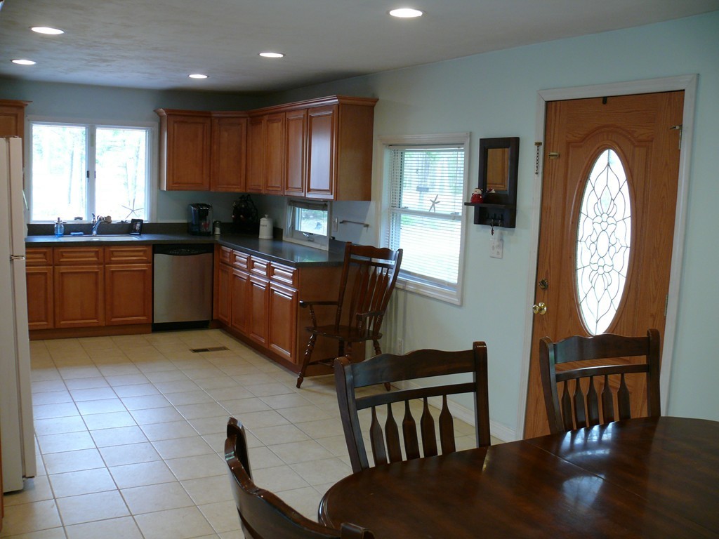 188 Mason Road Townsend, MA 01474 - Photo 6 of 22 a kitchen with granite countertop a stove a sink a dining table and chairs