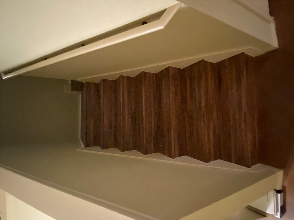 4527 Secure Lane, Unit 32 Austin, TX 78725 - Photo 9 of 9 Staircase featuring wood finished floors and baseboards