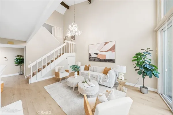 a living room with furniture and a chandelier