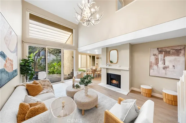 a living room with furniture fireplace and a large window