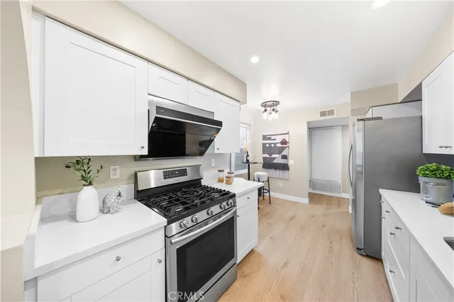 a kitchen with a stove and a refrigerator