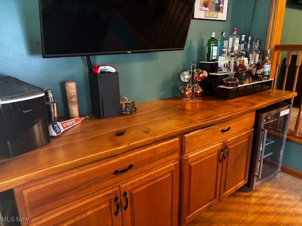 4270 Mellinger Road Canfield, OH 44406 - Photo 15 of 49 Indoor dry bar with wooden counters, beverage cooler, dark wood-style flooring, and brown cabinets