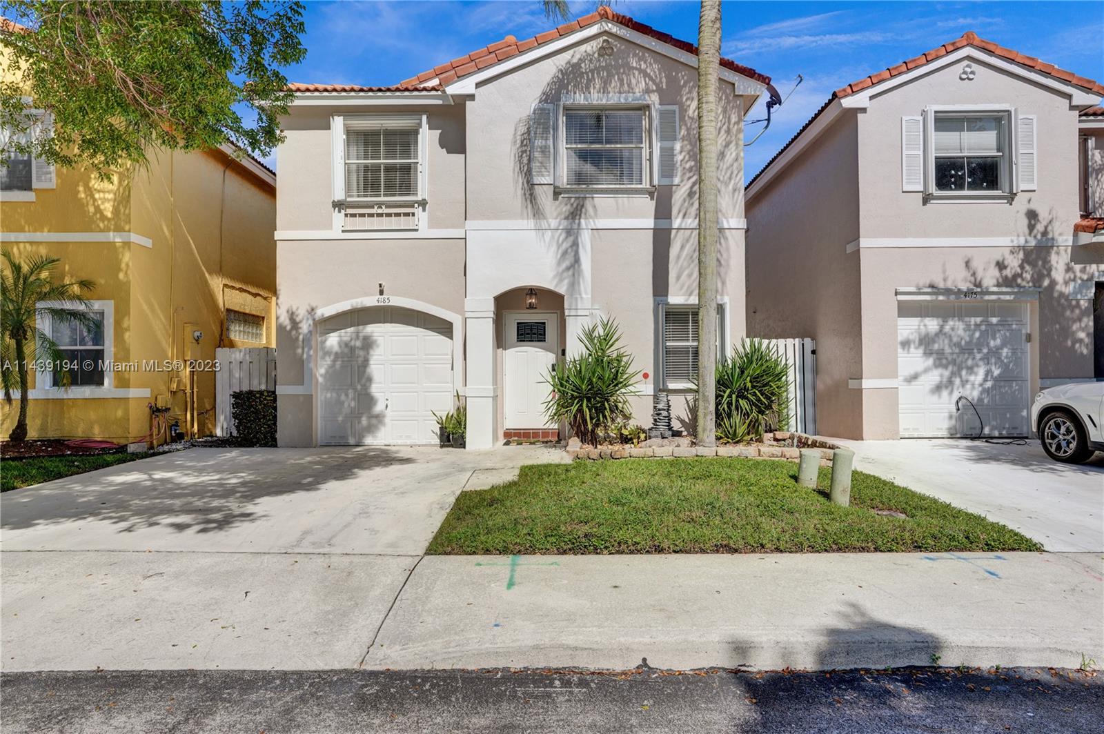 4185 Tree Top Road Cooper City, FL 33026 - Photo 1 of 36 a front view of a house with a yard and garage