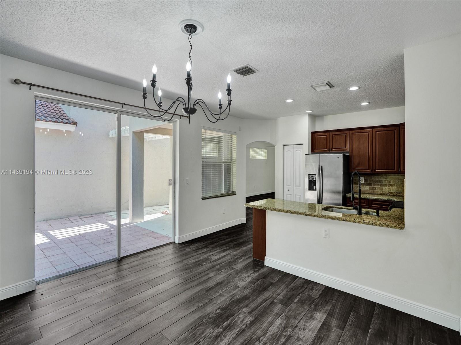 4185 Tree Top Road Cooper City, FL 33026 - Photo 13 of 36 a kitchen with stainless steel appliances a refrigerator sink and microwave