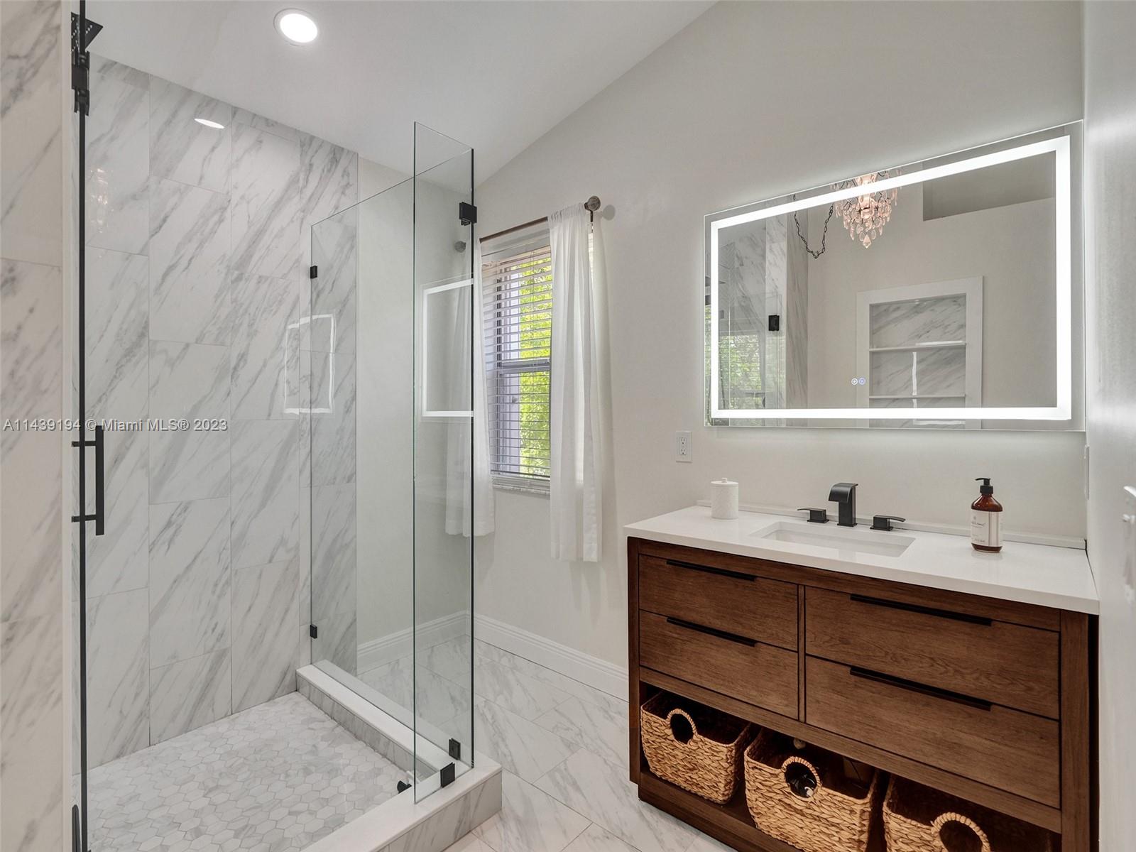 4185 Tree Top Road Cooper City, FL 33026 - Photo 17 of 36 a bathroom with a double vanity sink mirror and shower