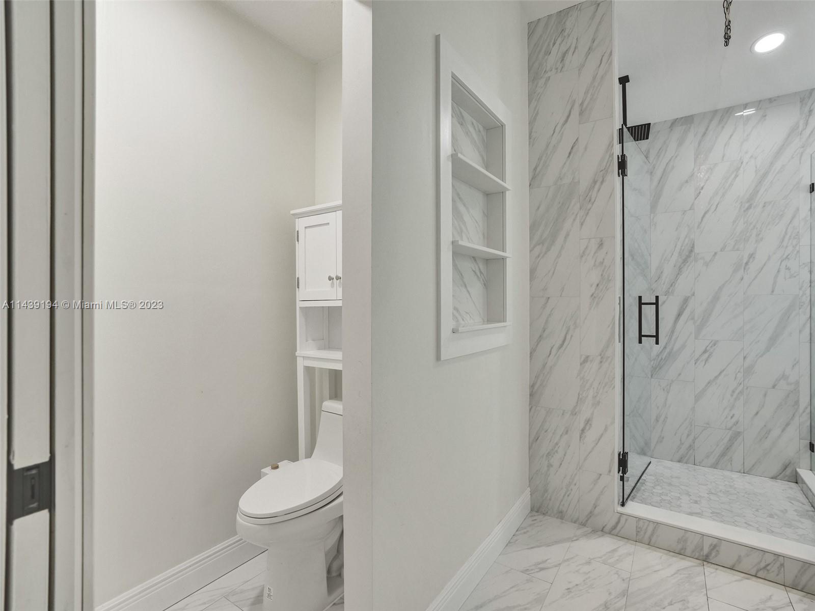 4185 Tree Top Road Cooper City, FL 33026 - Photo 19 of 36 a bathroom with a shower and a toilet