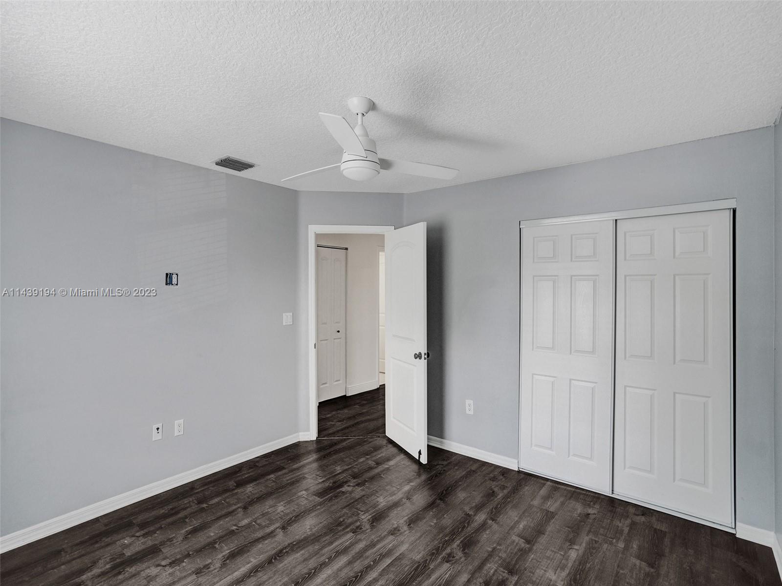 4185 Tree Top Road Cooper City, FL 33026 - Photo 20 of 36 a view of an empty room with wooden floor