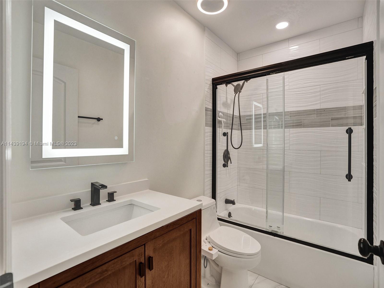 4185 Tree Top Road Cooper City, FL 33026 - Photo 26 of 36 a bathroom with a sink a toilet and shower