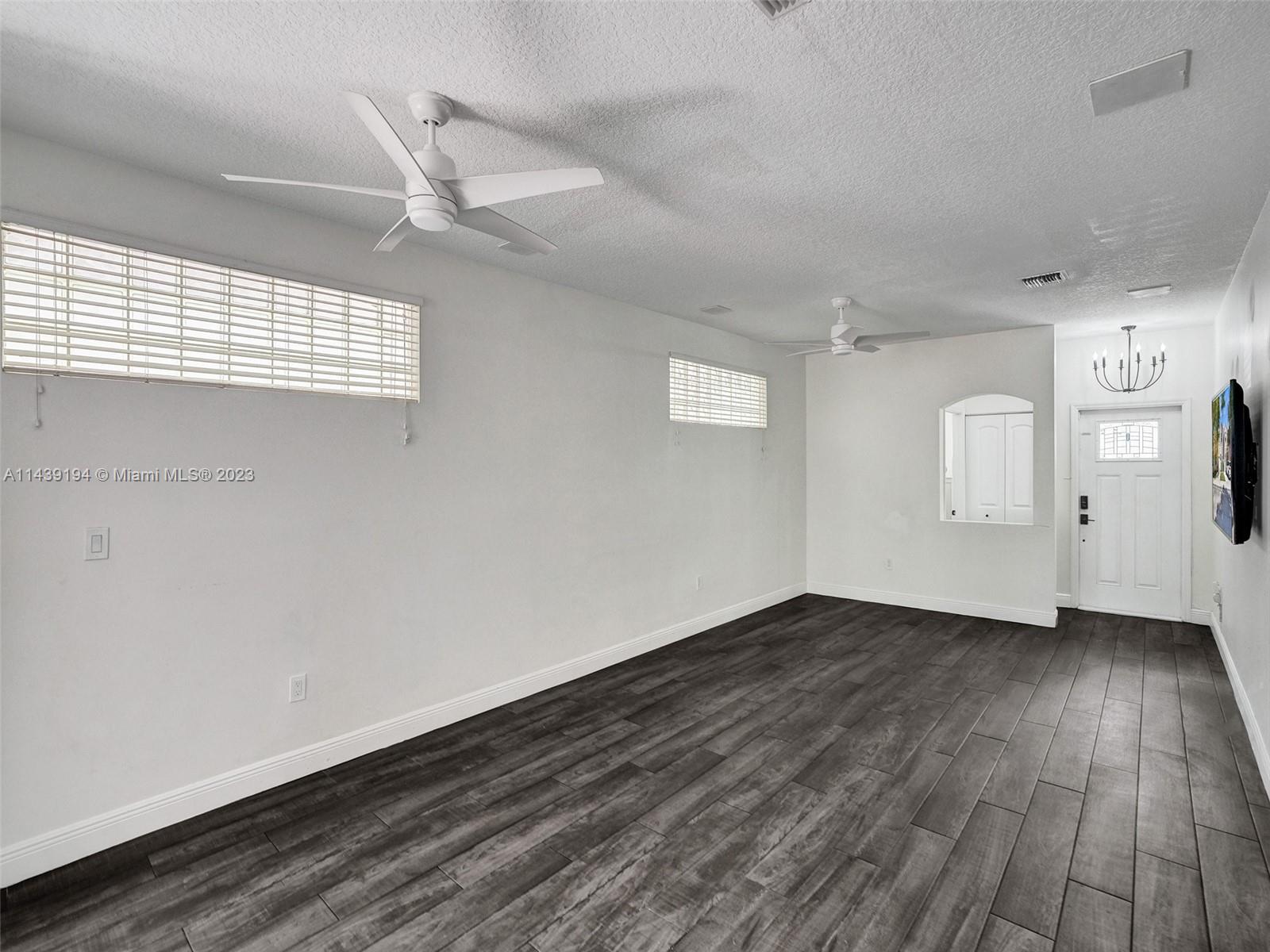 4185 Tree Top Road Cooper City, FL 33026 - Photo 5 of 36 wooden floor in an empty room