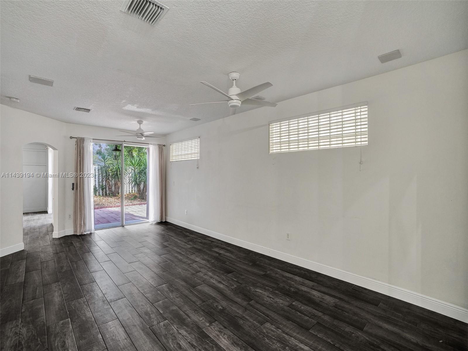 4185 Tree Top Road Cooper City, FL 33026 - Photo 7 of 36 wooden floor in an empty room with a window
