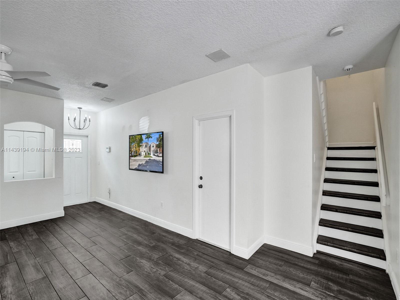 4185 Tree Top Road Cooper City, FL 33026 - Photo 8 of 36 a view of a room with wooden floor