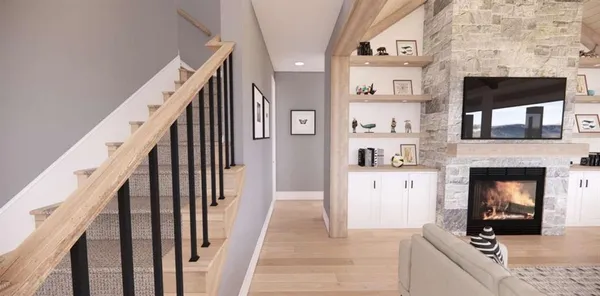 a view of a kitchen and an entryway with fireplace