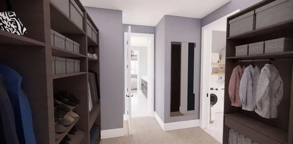 a view of walk in closet with clothes and shoes