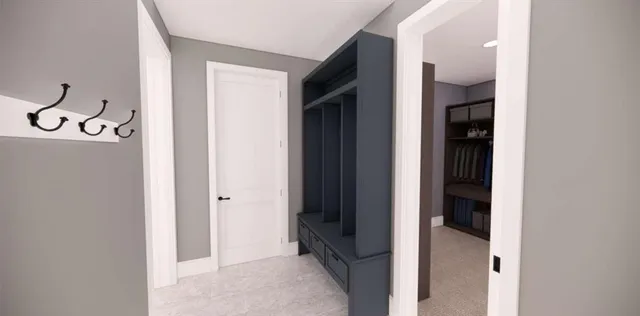 a view of a hallway with wooden floor and a bathroom