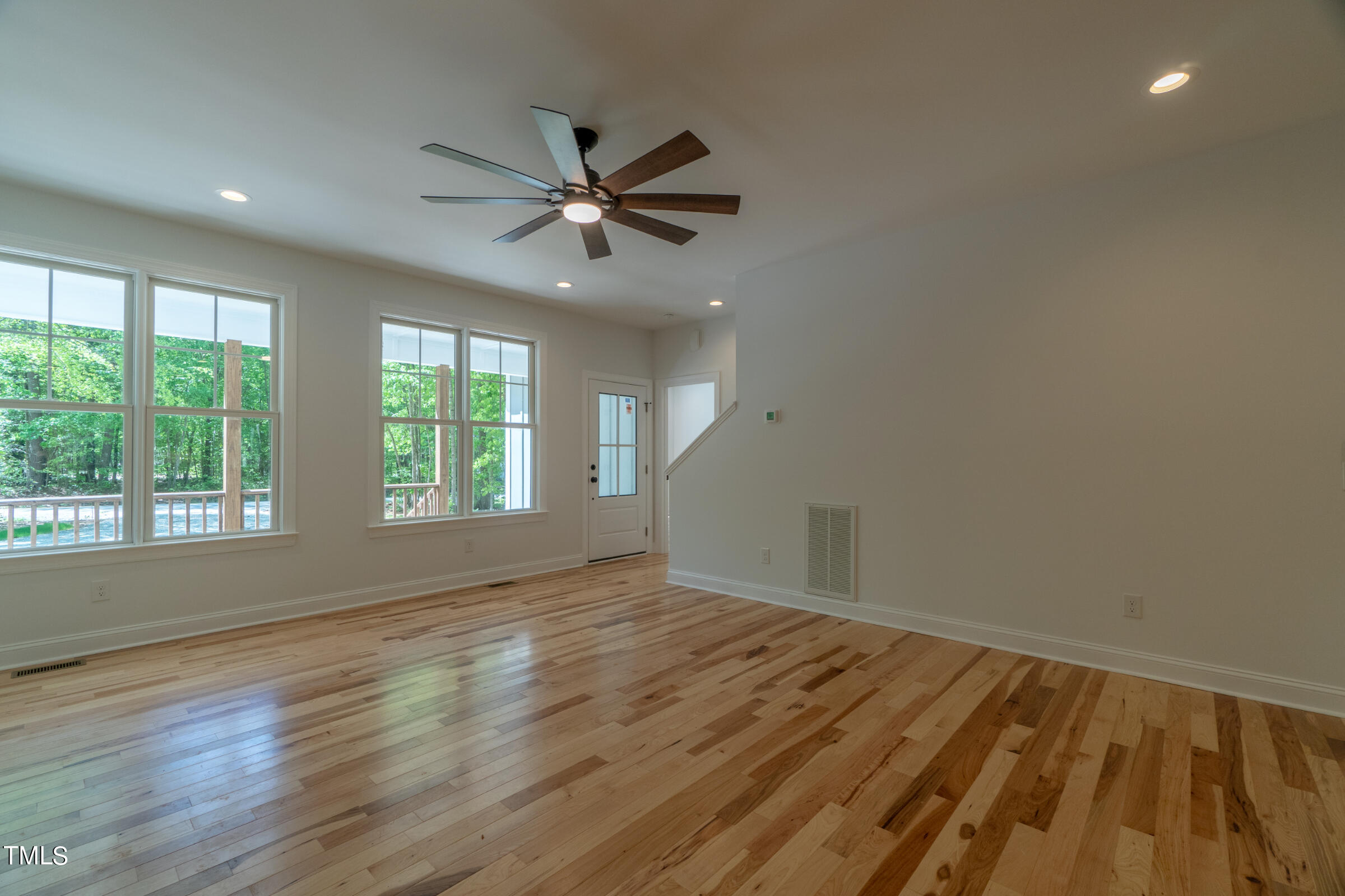 206 Goose Lane Mebane, NC 27302 - Photo 11 of 37 a view of empty room with wooden floor and fan