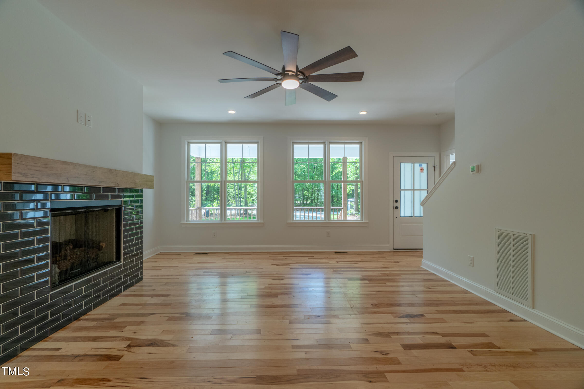 206 Goose Lane Mebane, NC 27302 - Photo 12 of 37 a view of an empty room with wooden floor fireplace and a window