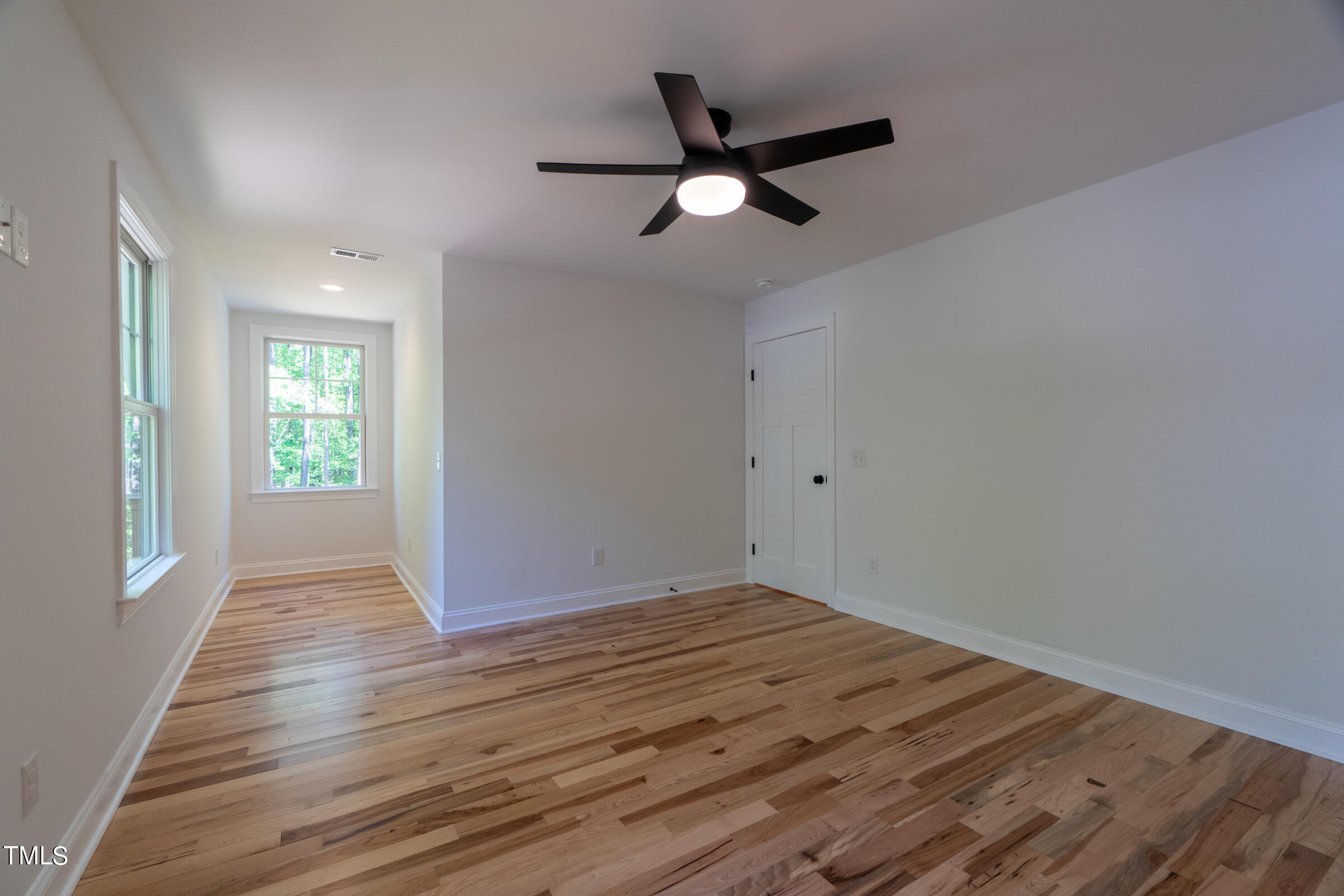 206 Goose Lane Mebane, NC 27302 - Photo 27 of 37 an empty room with wooden floor fan and windows
