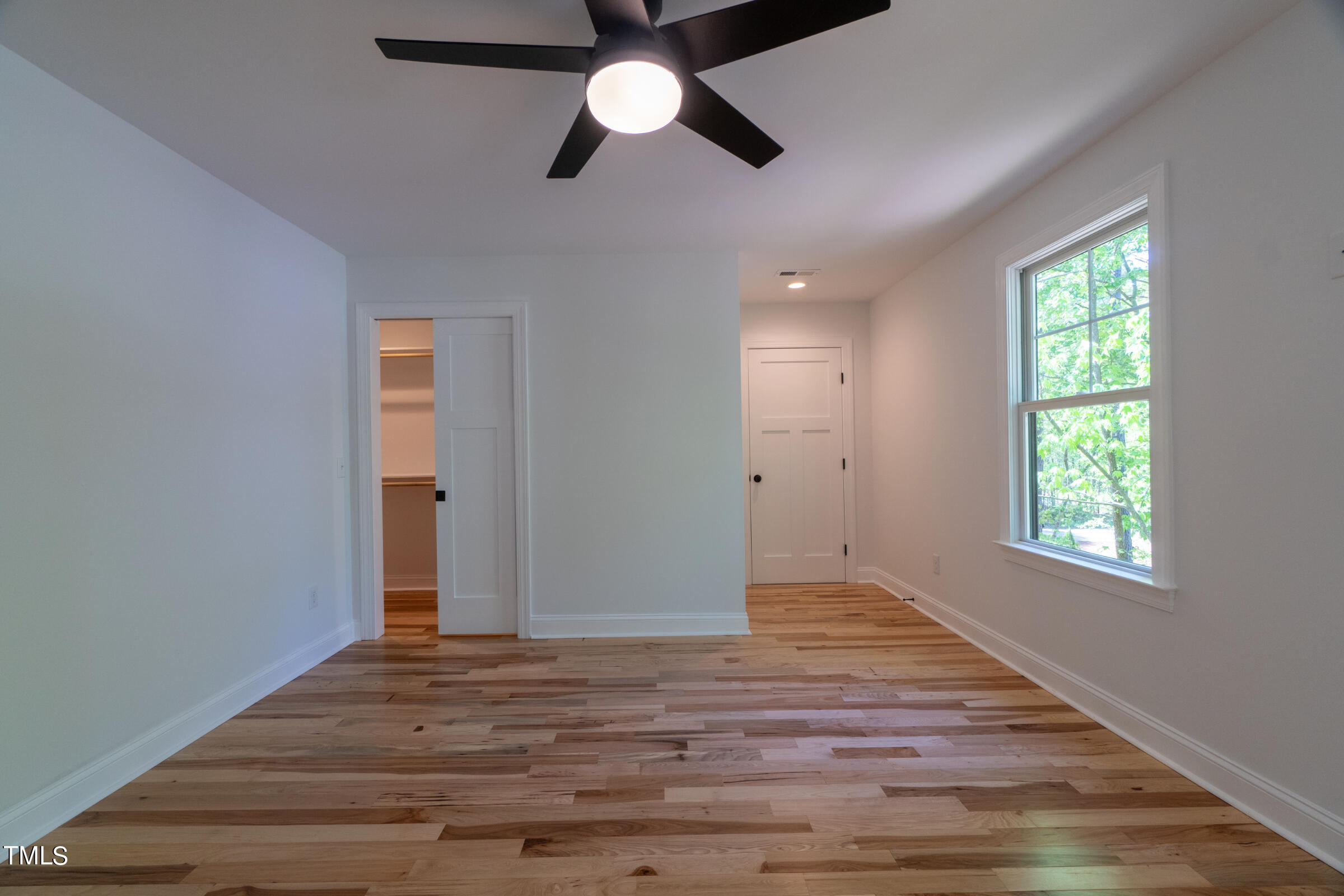 206 Goose Lane Mebane, NC 27302 - Photo 28 of 37 an empty room with wooden floor chandelier fan and windows