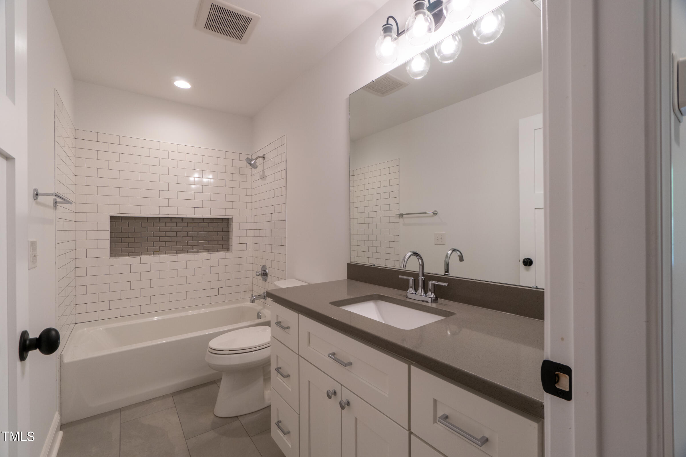 206 Goose Lane Mebane, NC 27302 - Photo 29 of 37 a bathroom with a granite countertop sink a toilet a mirror and shower