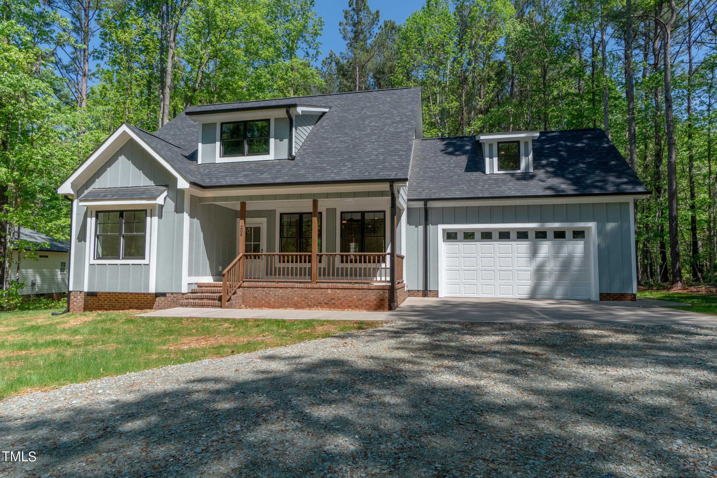 206 Goose Lane Mebane, NC 27302 - Photo 3 of 37 a front view of a house with a garden and yard