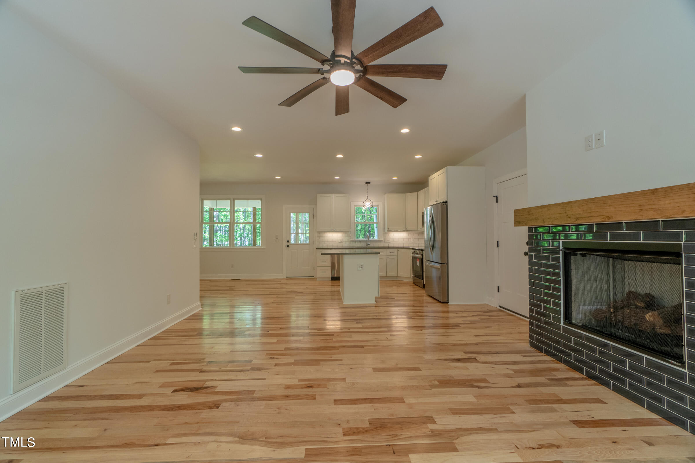 206 Goose Lane Mebane, NC 27302 - Photo 9 of 37 a view of empty room with wooden floor and fireplace