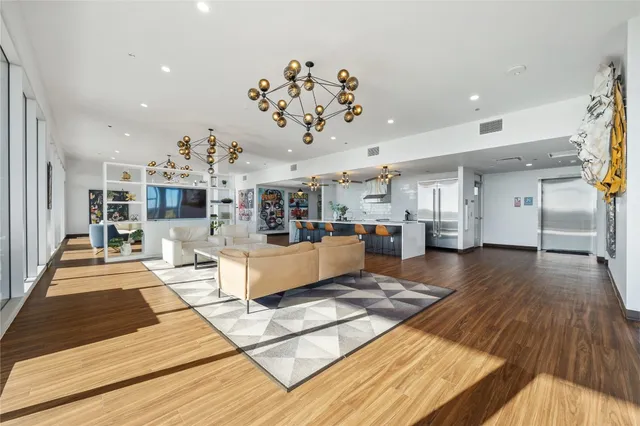 a living room with furniture fireplace and wooden floor