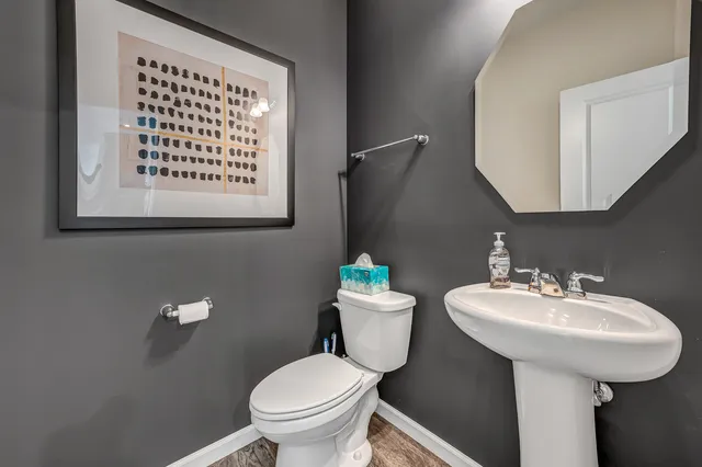 a bathroom with a sink toilet and a mirror