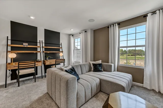 a bedroom with furniture and a flat screen tv