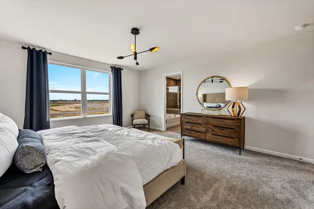 a bedroom with a bed dresser and a window