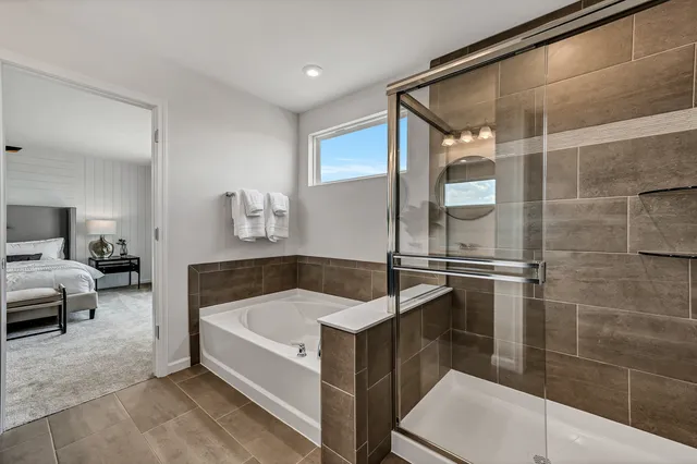 a bathroom with a tub and shower