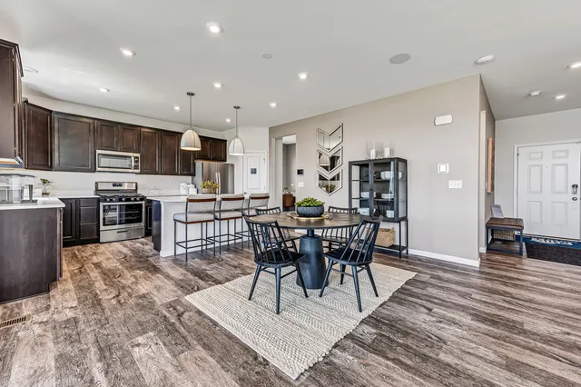 a view of a dining room with furniture and wooden floor