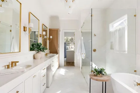 a spacious bathroom with a granite countertop tub a sink and a large mirror