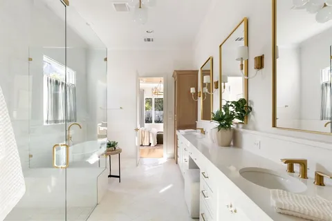 a spacious en suite bathroom with a granite countertop tub and shower