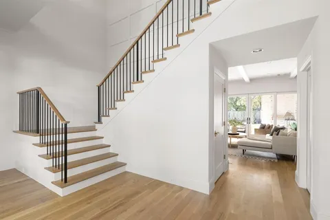a view of entryway and hall with wooden floor