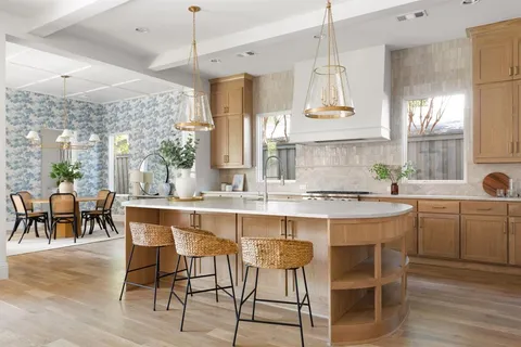a kitchen with a dining table chairs sink and granite counter tops
