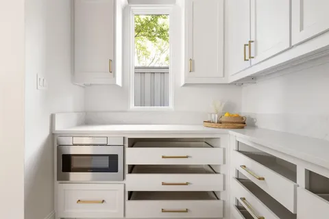 a kitchen with appliances cabinets and a window
