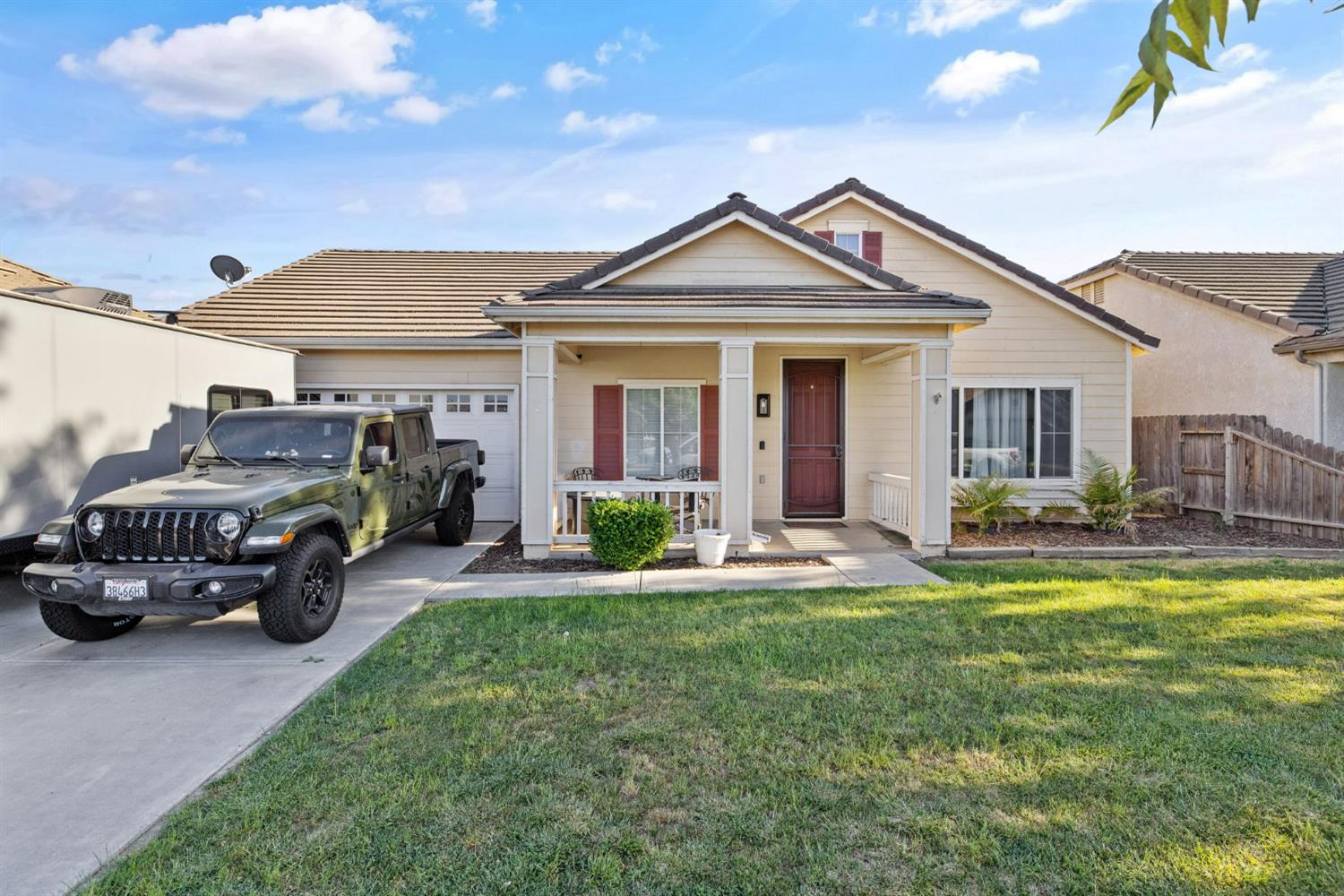 a view of a house with a patio and a yard
