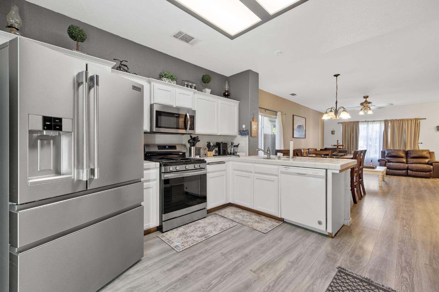 1963 West Merritt Street Hanford, CA 93230 - Photo 14 of 32 a kitchen with stainless steel appliances a refrigerator sink and microwave