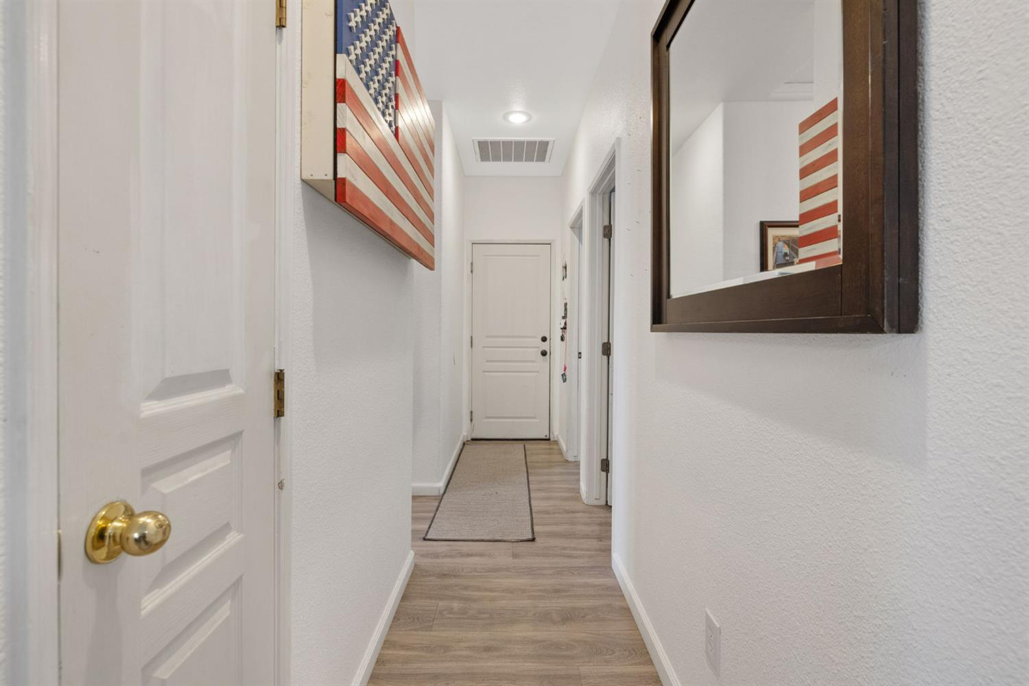 1963 West Merritt Street Hanford, CA 93230 - Photo 15 of 32 a view of a hallway with wooden floor and staircase